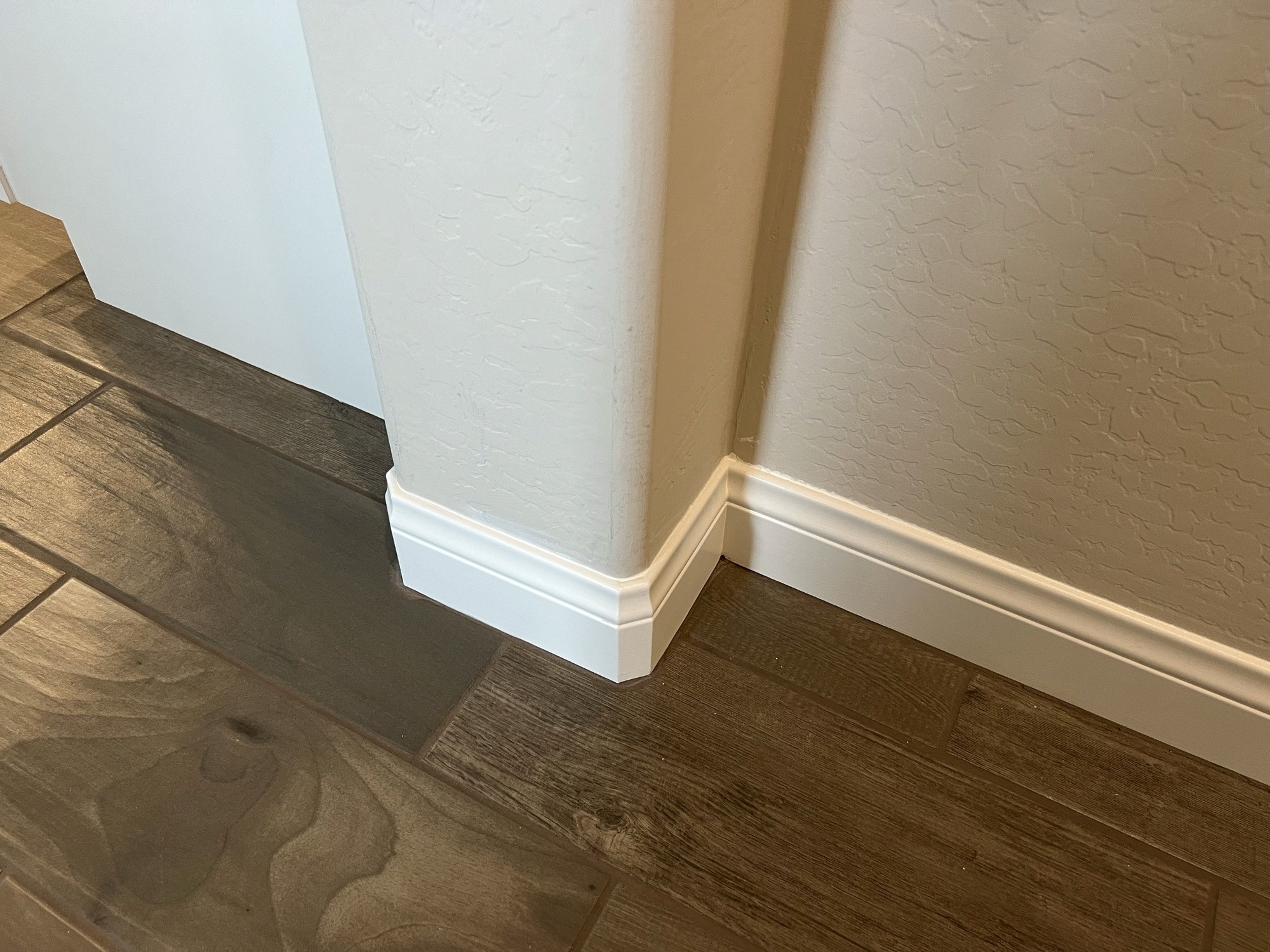 Detail shot of finished baseboard trim at a wall corner