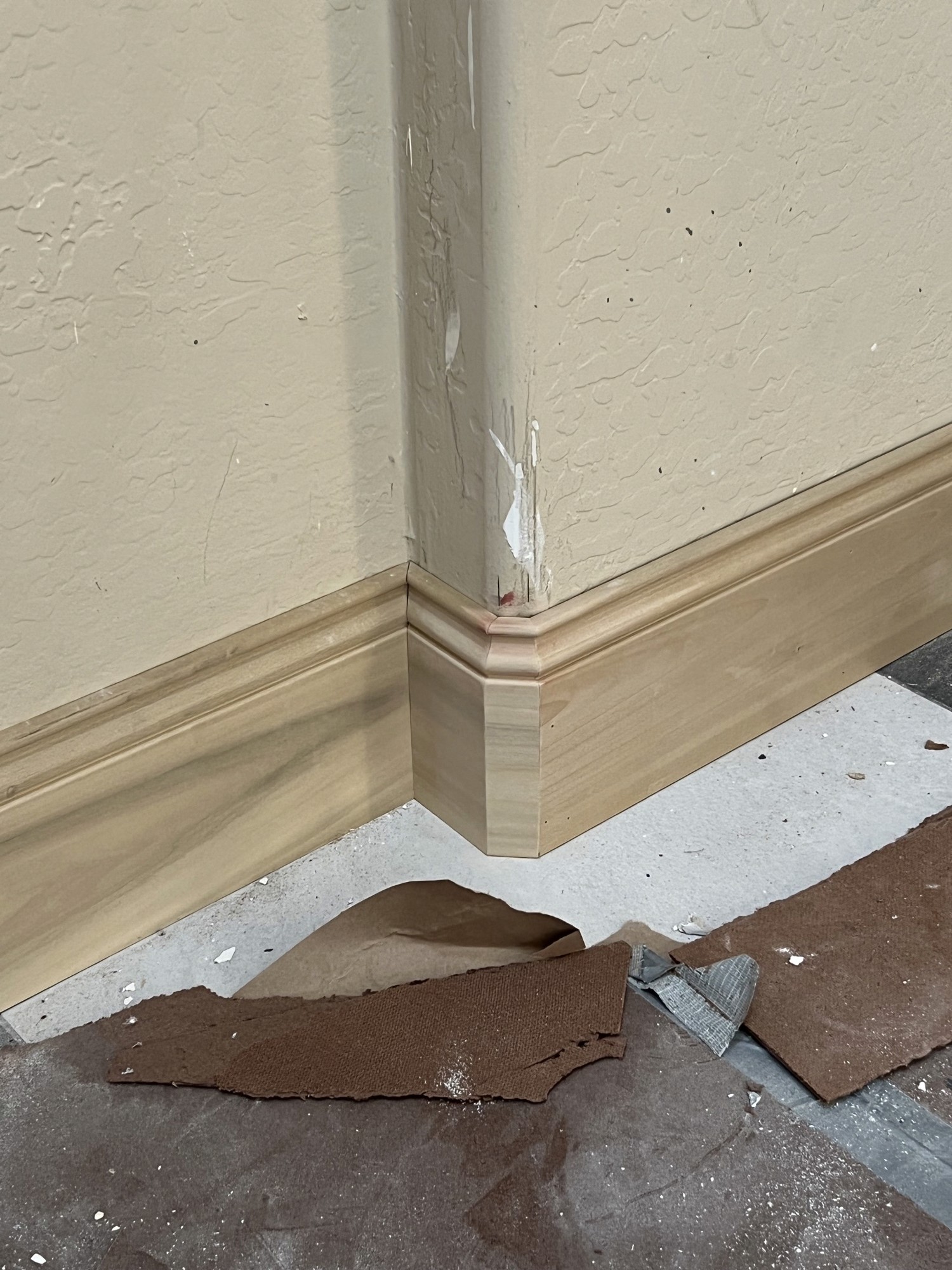Baseboard trim installation detail in progress