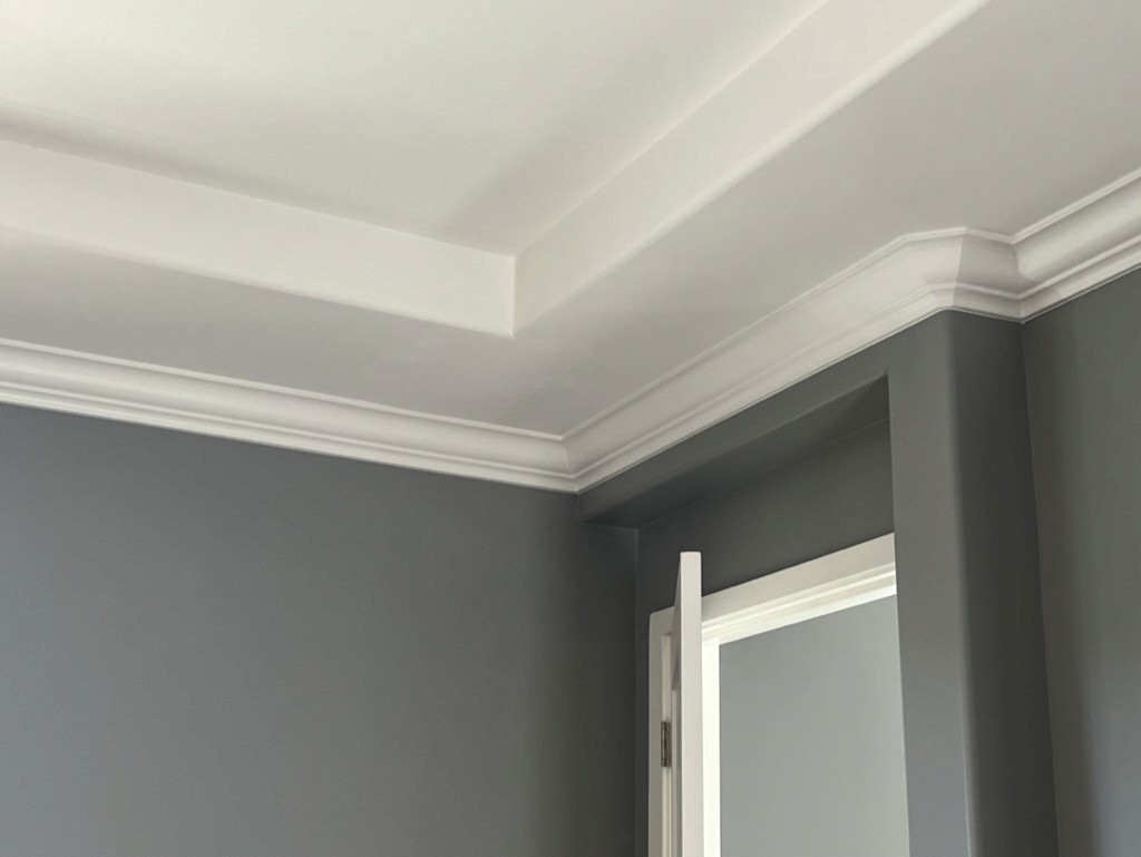 Crown molding corner detail at a ceiling and doorway