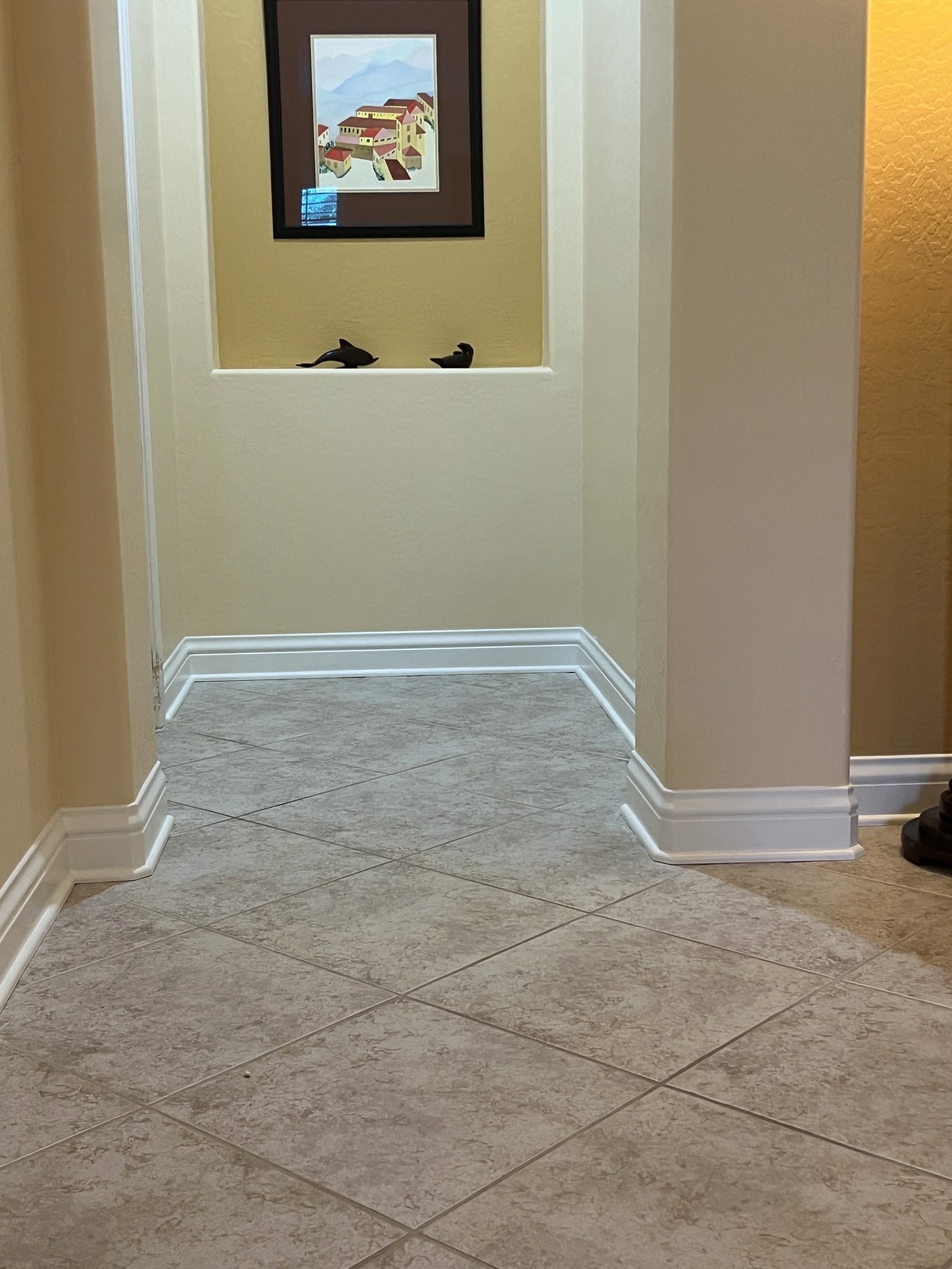 Hallway corner with finished baseboard and crown trim