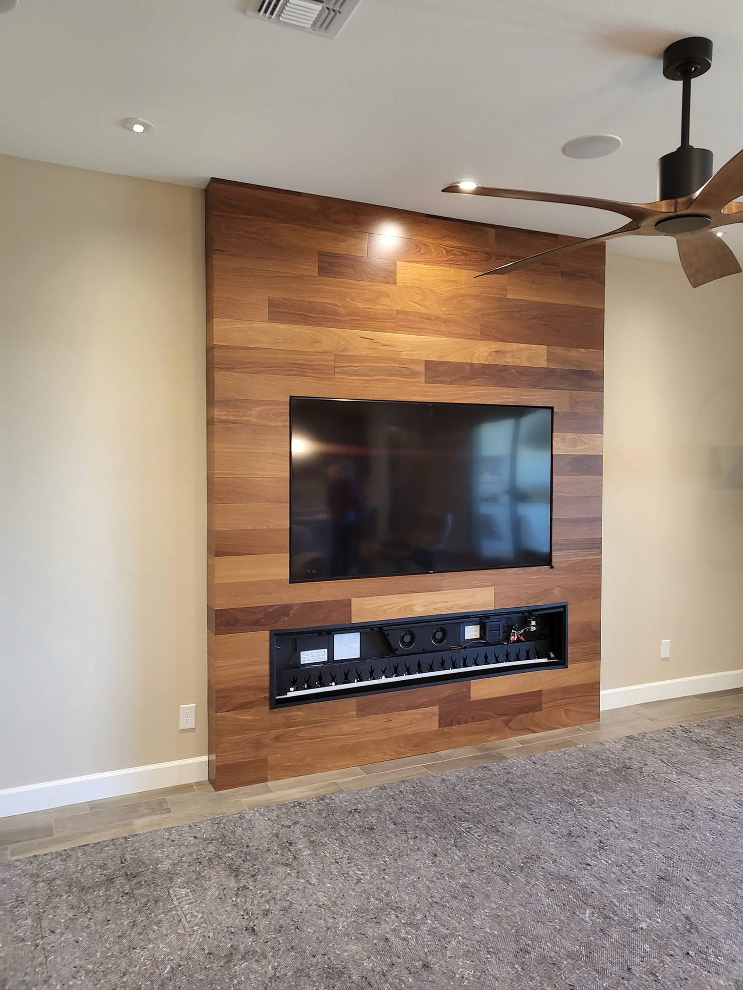 Custom wood plank accent wall with a recessed media niche